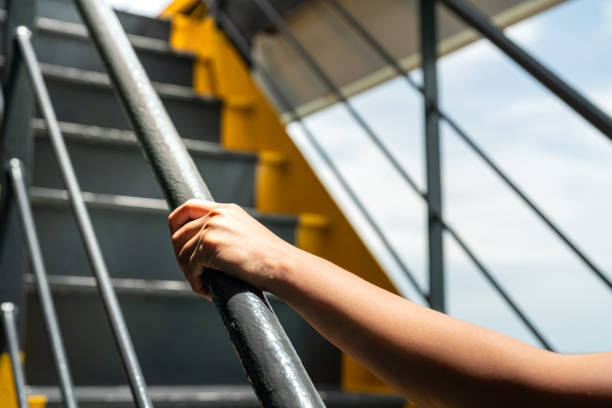 istock Holding the handrail banister during walking up. 2157700398