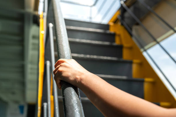 istock Holding the handrail banister during walking up. 2157700399