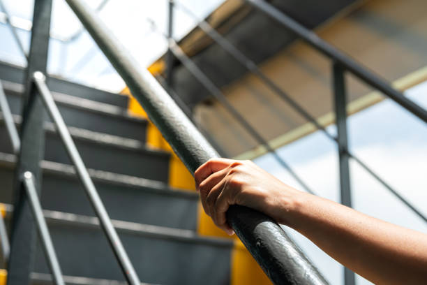 Holding the handrail banister during walking up.