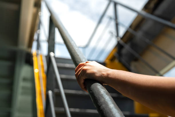 istock Holding the handrail banister during walking up. 2157700401
