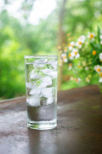 istock a glass of cold water with ice on rustic table. 2157700442