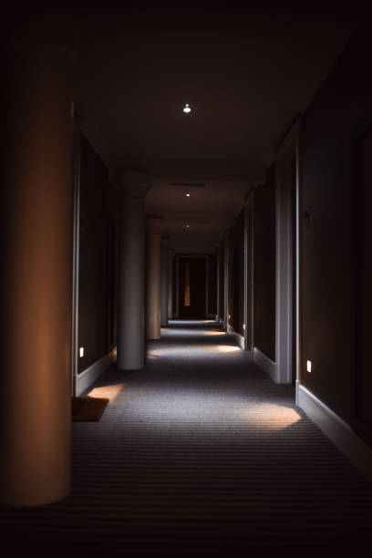 istock Long dark corridor in hotel building in York, Yorkshire, UK 2157701677