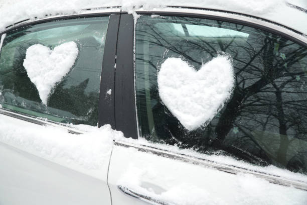 istock snow in heart shape on windshield of the car 2157701830