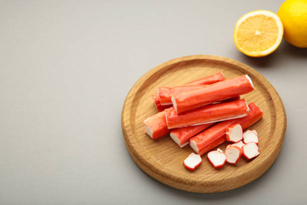 istock Cut crab sticks in bowl on grey background. Space for text 2157704062