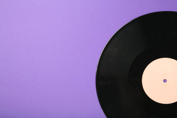 Gramophone vinyl record isolated on violet background. Top view