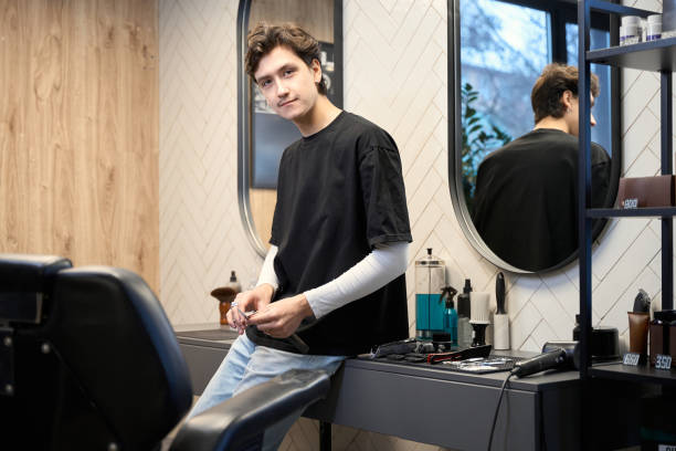 istock Experienced barber posing at camera in contemporary hairdressing salon 2157705891