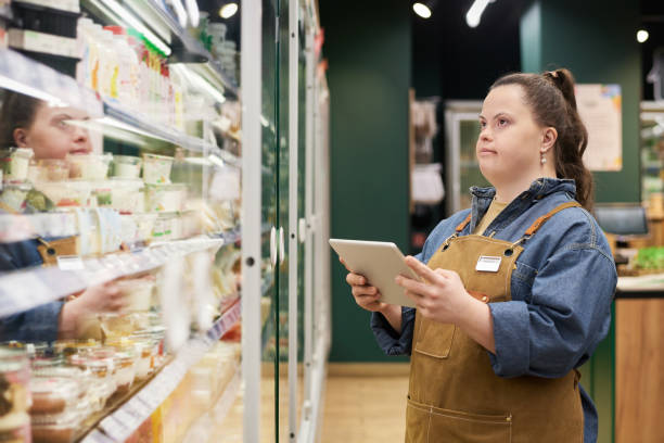 istock Girl with Disability Working in Supermarket at Digital Tablet 2157705987