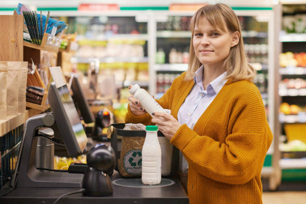 istock Woman in Supermarket at Self Checkout 2157706104