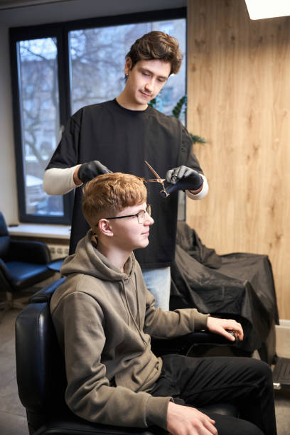 istock Handsome barber working in contemporary hairdressing salon 2157706200