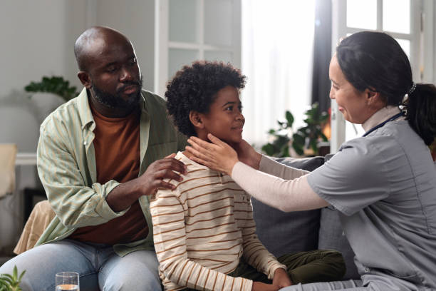 istock Friendly Happy Nurse Examining Black Boy During Visit 2157706843