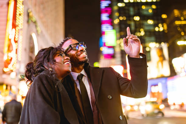 istock Elegantly Dressed Couple in Times Square at Night 2157707964