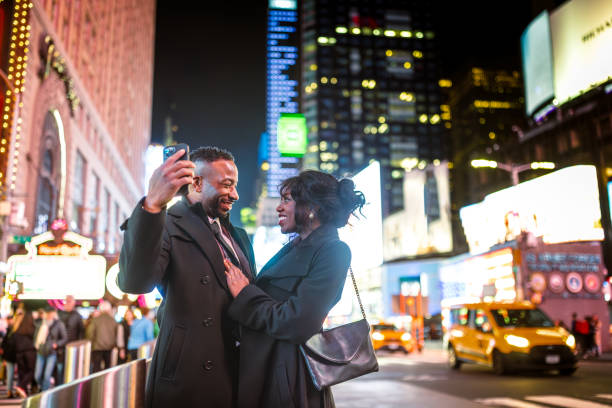 istock Elegantly Dressed Couple in Times Square at Night 2157708035