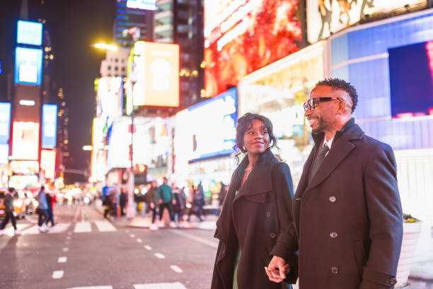 istock Elegantly Dressed Couple in Times Square at Night 2157708082