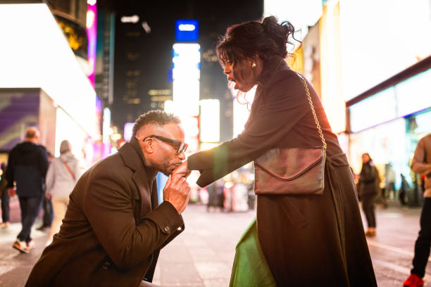 istock Elegantly Dressed Couple proposal in Times Square 2157708116
