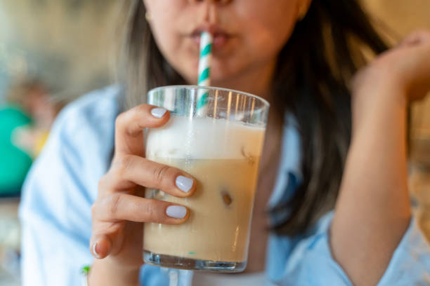 istock woman drinks coffee with cold milk 2157708429