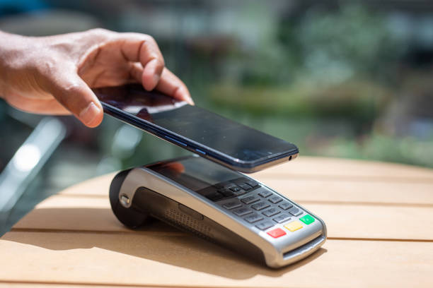 istock person mobile phone payment terminal. 2157708737