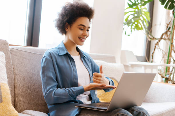 istock African American woman using laptop, having video conference, communicating with sign language 2157709206