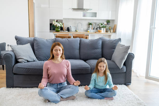 istock Mother and daughter practicing meditation at home 2157710962