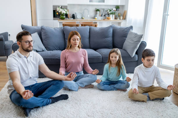 istock Family of four practicing meditation together 2157710966