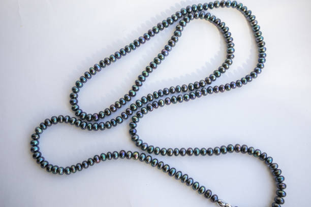 istock Black pearls on a light background, luxurious beads 2157711935
