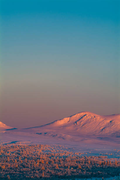 View from a ski slope at Voss Alpine Ski Resort in Norway, Scandinavia, Europe in winter (late February). The image was captured with a full frame mirrorless camera and a sharp telephoto lens at low ISO. The photograph is part of a series of images of Norwegian ski resorts.