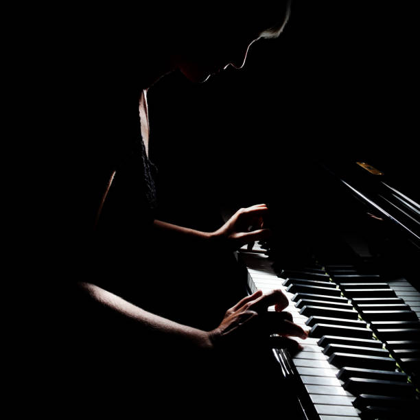 istock Piano player. Pianist playing grand piano 2157712656