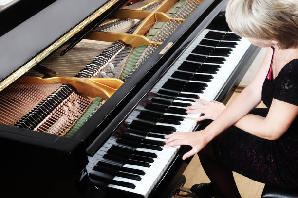 Piano player. Pianist playing grand piano musical instrument close up