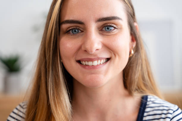 istock Young woman smiling showing white teeth with braces 2157713092