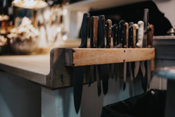 istock Chef's knives along edge of commercial kitchen counter in rustic event space 2157713690