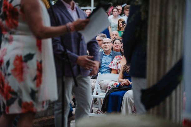 istock Smiling guests attending gay wedding ceremony 2157713693