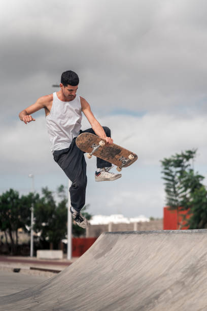 istock young man skates in a skate park in a cloudy day 2157714324