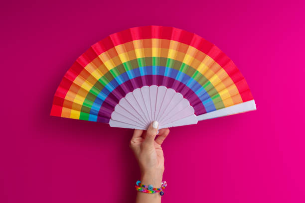 istock Hand with beautiful colorful fan, on color background 2157714773