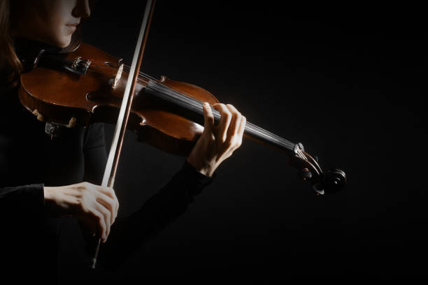 istock Violin player. Violinist hands playing violin 2157716317