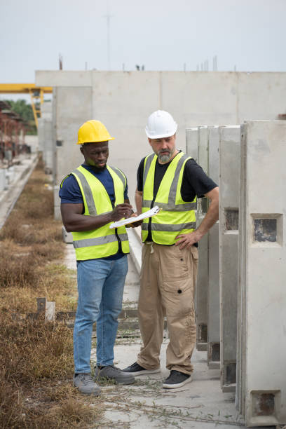 istock Portrait African engineer man working with caucasian engineer man at precast cement outdoor factory 2157717028