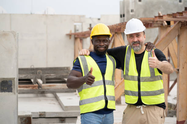 istock Portrait caucasian engineer man shoulder hug with happy African engineer man at precast cement outdoor factory 2157717050