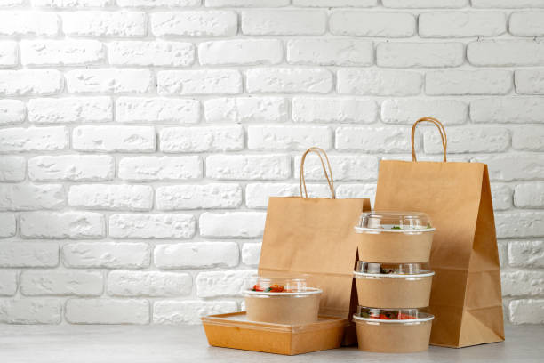 istock Take out food in boxes and craft bag against brick background 2157717441