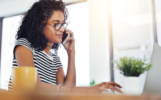 istock Happy, woman or student with phone call and laptop for elearning, feedback and remote work on essay. Smile, female person and online course with mobile for advice and help from university hotline 2157718932