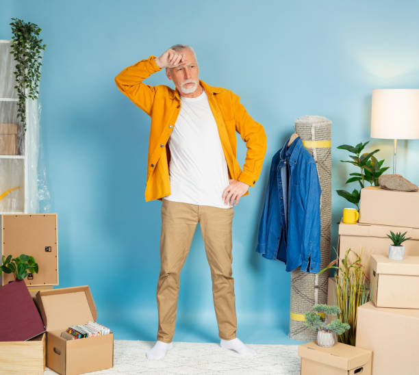 istock Pensive man standing near boxes with belongings at new house 2157719082