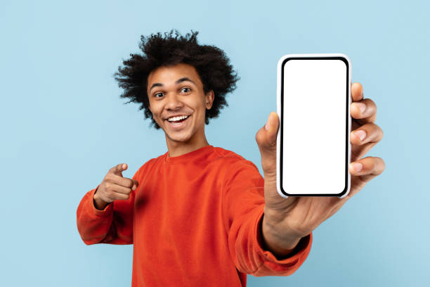 istock Man showcasing smartphone with blank screen on blue background 2157720972