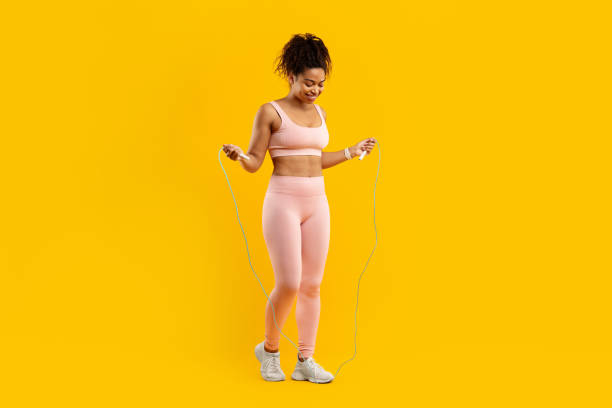 istock Lady with jump rope on a bright yellow background 2157721080