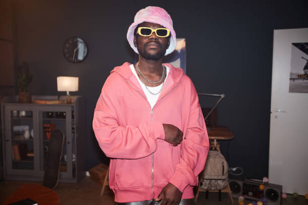istock Black Young Man Wearing Pink Outfit with Flash 2157721961