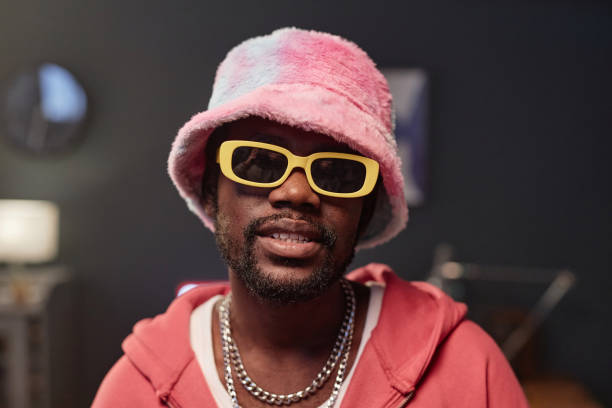 istock Black Man Wearing Pink Fur Hat with Dramatic Light 2157721963