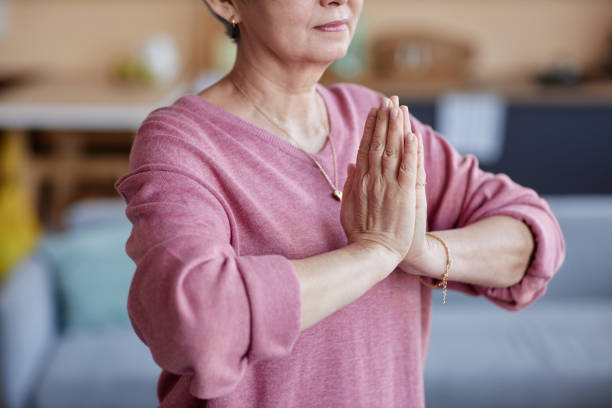 istock Senior Woman Doing Yoga Namaste Pose 2157722201