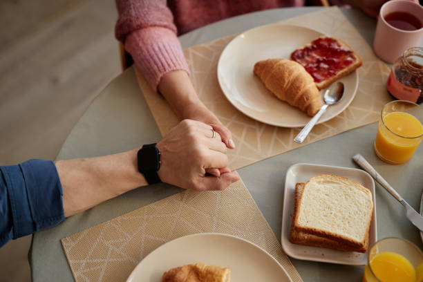 istock Top View Adult Couple Holding Hands at Table 2157722237