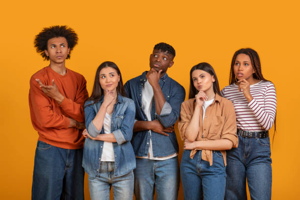 Group of five young people posing thoughtfully