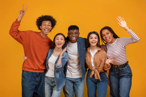 istock Cheerful friends making peace sign and smiling 2157722355