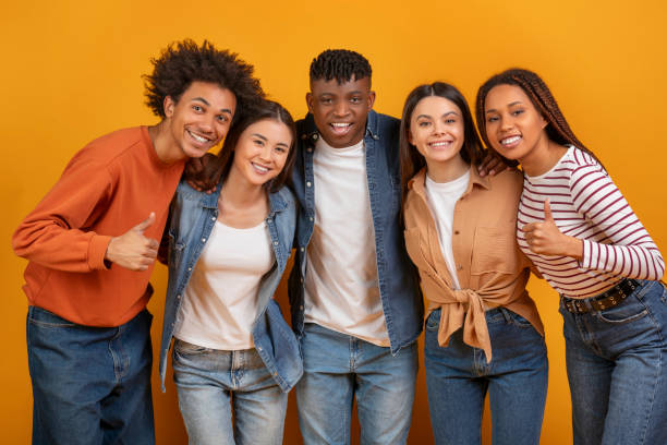istock Happy diverse group of friends posing on orange background 2157722366