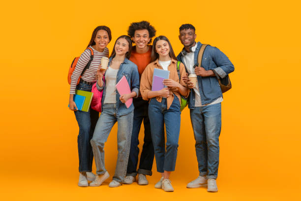 istock Friends with backpacks ready for school on orange background 2157722453