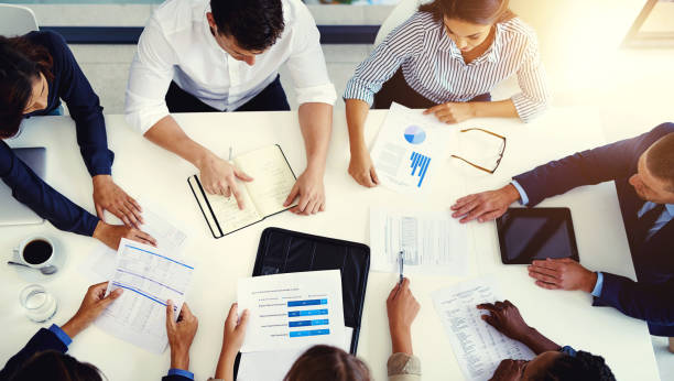 istock Documents, above and business with people in meeting for strategy planning, teamwork and collaboration for analytics sales. Corporate, finance and group with support, digital or data statistics 2157722551