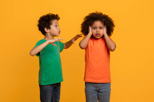istock Two African American Boys Arguing on Yellow Background 2157723225